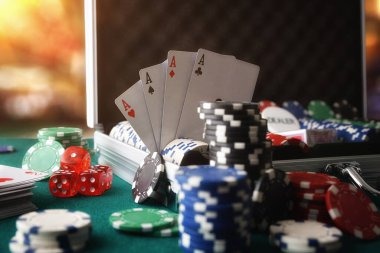 Close-up view of a poker table showing chip stacks and community cards on sensa777